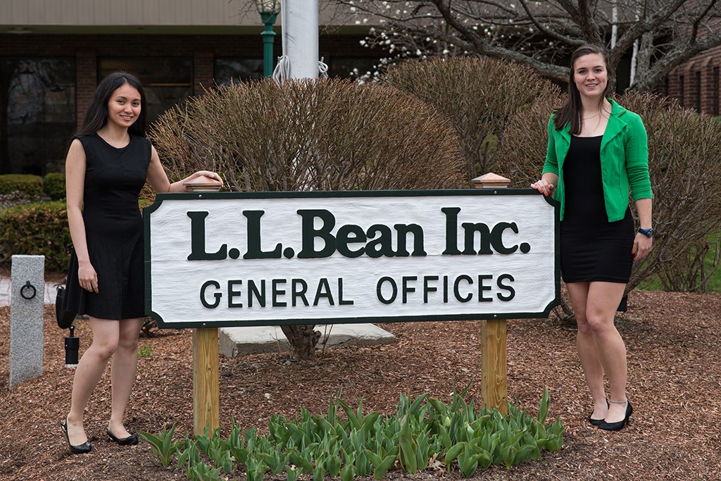 Two U N E students at their internship site, L.L. Bean