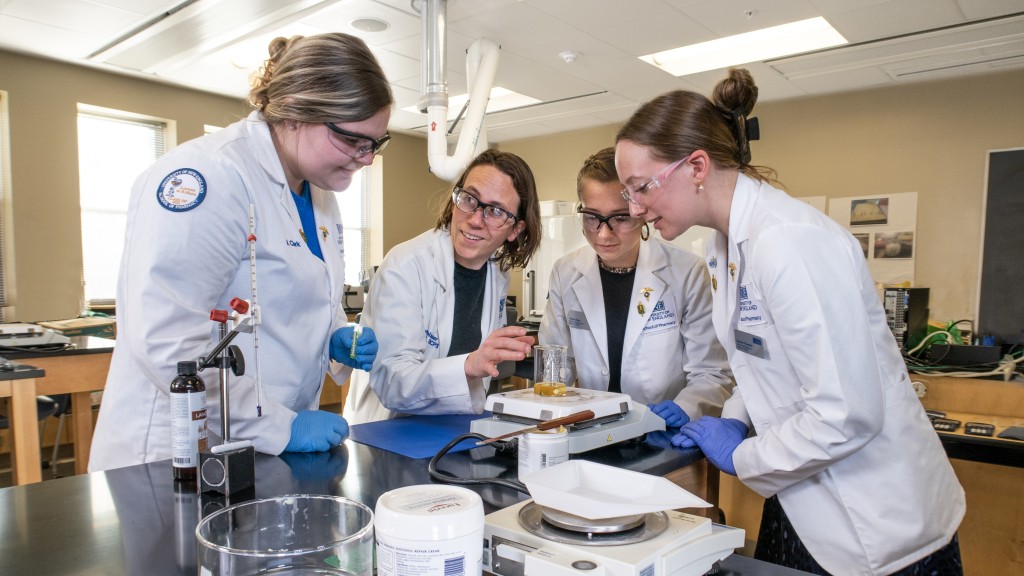 Students and faculty conduct research in a Pharmacy lab