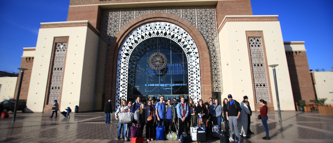 Students arrive at the Marrakesh train station during a group excursion.