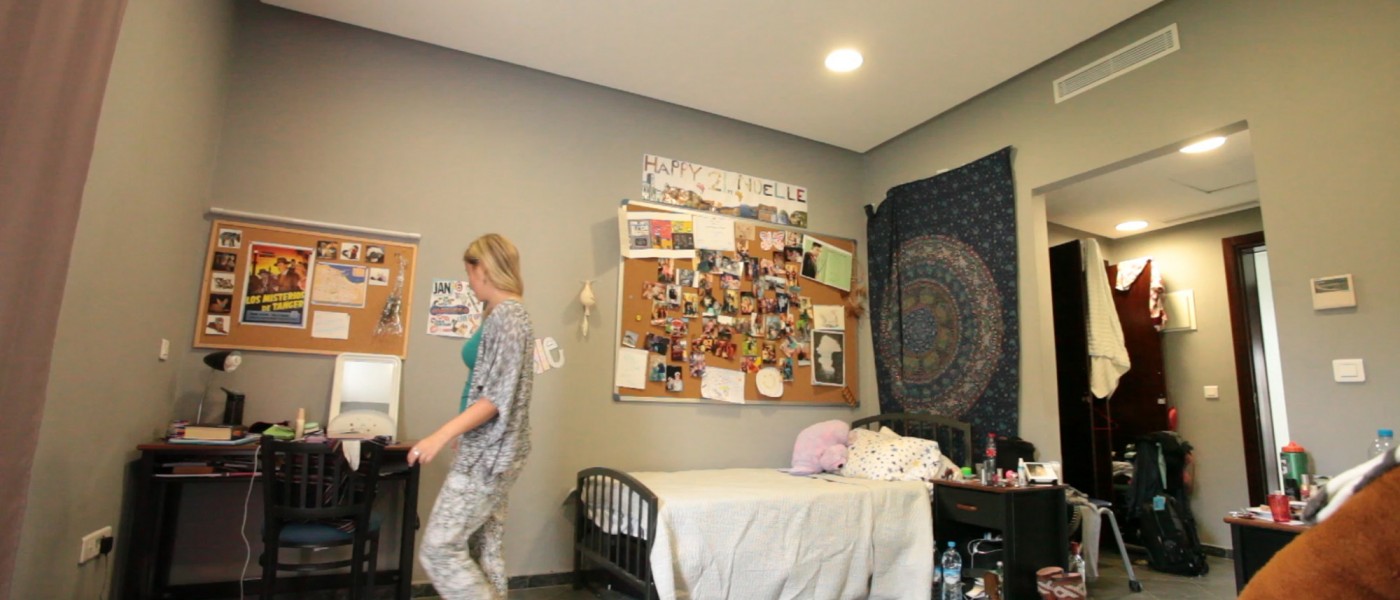 A student prepares for class in her modern dorm room within the U N E Tangier residences