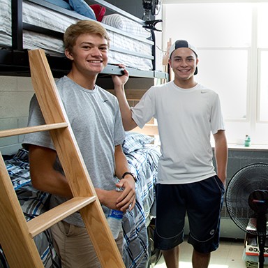 Two U N E students moving into their freshman dorm room